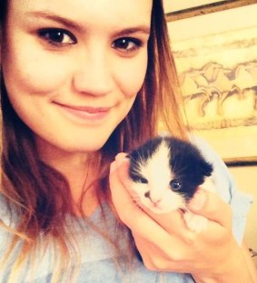 Moo's owner Mady White, pictured with one of its kittens.