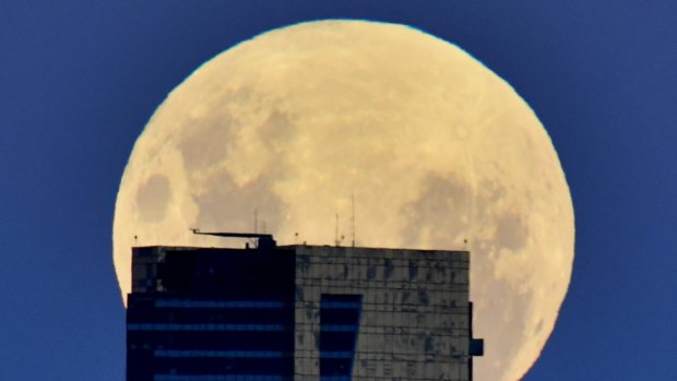 The Moon rises above the Eureka Tower, from Williamstown. 