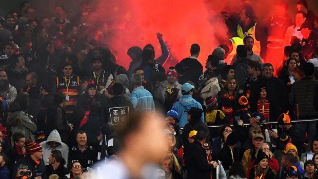 A flare is set off during the match between Adelaide and Geelong on Friday night.