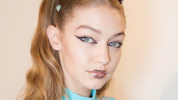 Model Gigi Hadid sporting Fendi's glitter lips at Milan Fashion Week.