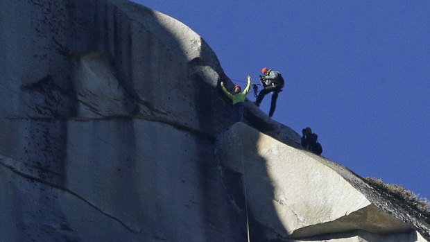 Peak experience: Tommy Caldwell raises his arms after reaching the summit of El Capitan.