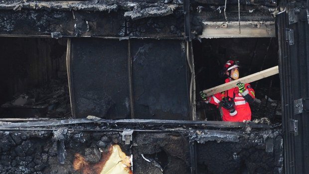 A London firefighter inside the charred Grenfell Tower.