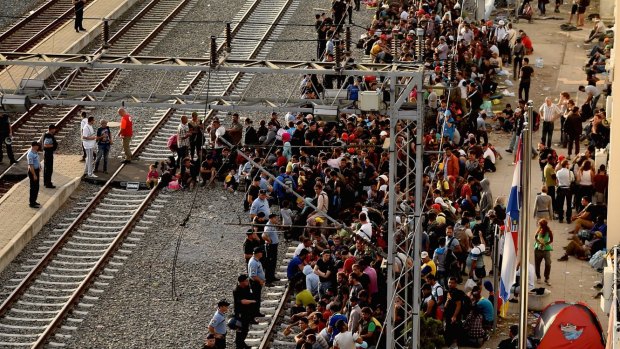 Migrants wait for a train to Zagreb from Tovarnik station in Croatia on their journey north despite moves by Slovenia and Hungary to hold them back.