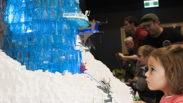 Natalia Rosa, 3, of Deakin, surveys Elsa in her Frozen Lego castle. 