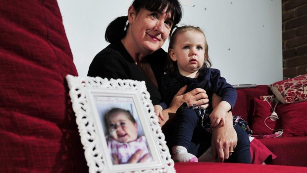 Suzanne Tunks with her daughter Ruby Tunks-Frawley a photo of her late daughter Stella in 2013.