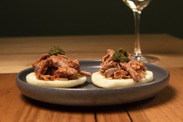 Arepitas topped with confit duck.