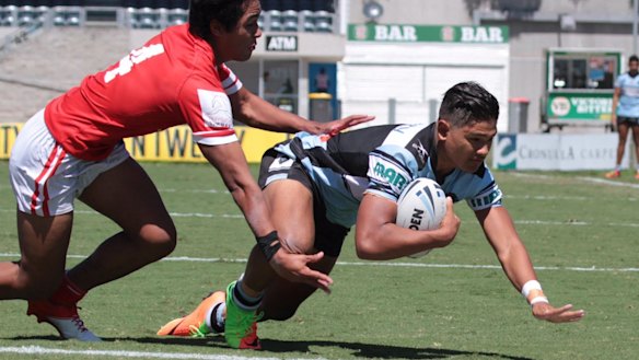 Sharks junior Douglas Levi dives in to score.