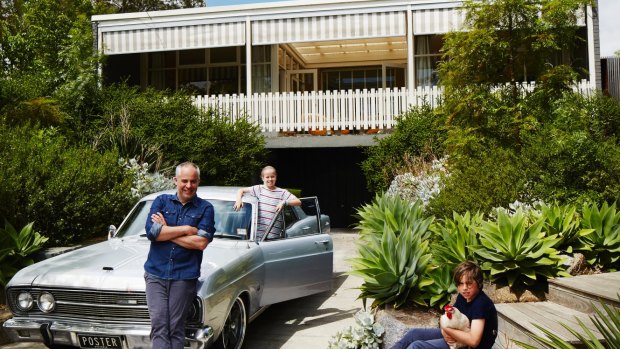 Sam, Gracie and Charlie with Fluffy the chicken outside their modernist home. “I’m caretaking a mate’s ZD Fairlane for a while,” says Sam.