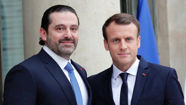 French President Emmanuel Macron greets Lebanon's Prime Minister Saad Hariri in Paris.