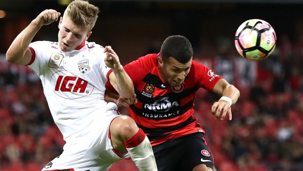 Stalemate: Riley McGree competes for the ball against Jaushua Sotirio.
