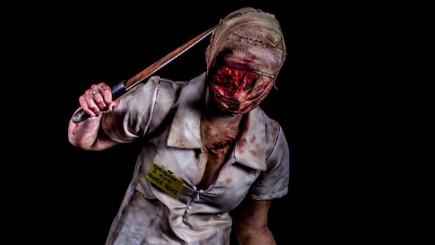 A fan imitates the nurse from the Silent Hill video game and horror movie after a makeover from special effects artist Kel McQueen. 