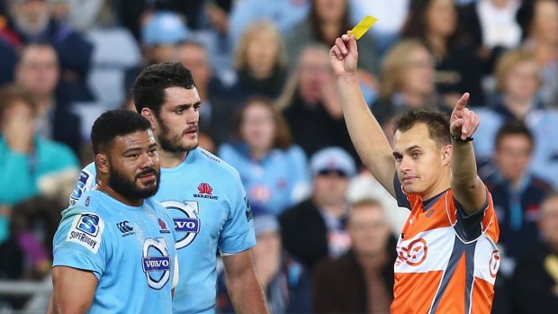 Unhappy: Tolu Latu (left) and David Dennis of the Waratahs look dejected as referee Marius van der Westhuizen shows Latu a yellow card during the match between the Waratahs and the Crusaders at ANZ Stadium.