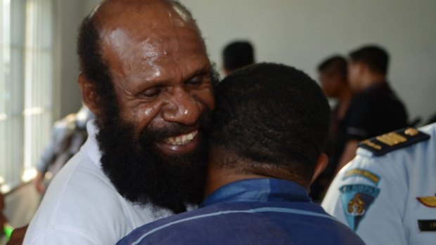 Freed Papuan political prisoner Kimanus Wenda is hugged by a supporter.