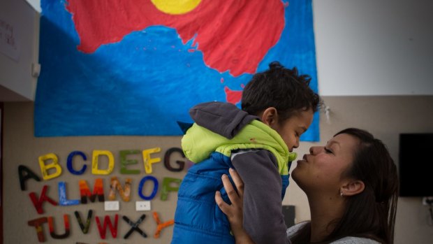 Djural Aldridge, 3, gets a kiss from mum Casey Tennyson at the Bubup Wilam Aboriginal child and family centre.