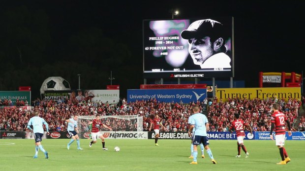Tribute: Phillip Hughes is seen on the big screen at the Wanderers-Sydney FC match on Saturday.