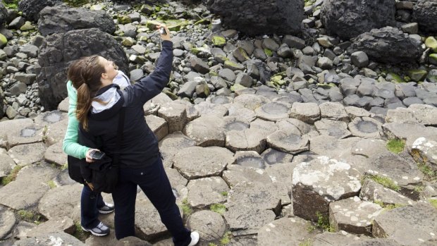 Tourists snap selfies at The Giant's Causeway, a Unesco world heritage site near filming locations for the HBO series "Game of Thrones" in County Antrim, Northern Ireland. 