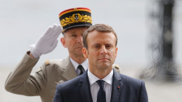 New French President Emmanuel Macron observes a minute of silence during a a ceremony at the Arc de Triomphe in Paris.