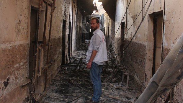 An employee of the Doctors Without Borders in the charred remains of the hospital earlier this month after it was hit by a US airstrike.