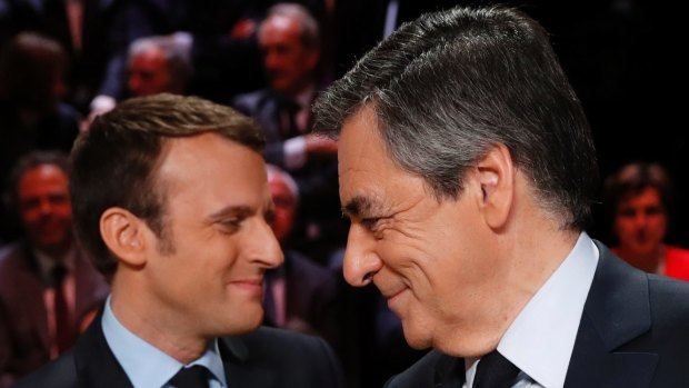 Emmanuel Macron, left, greets Francois Fillon.
