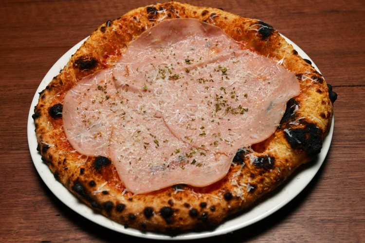 Classic cheese pizza with optional mortadella at Capitano restaurant in Carlton, Melbourne.