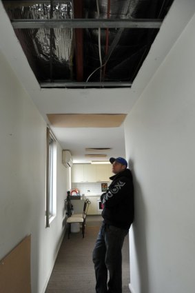Gaping holes in the ceiling of Grant Seears' apartment are causing the heat to escape.