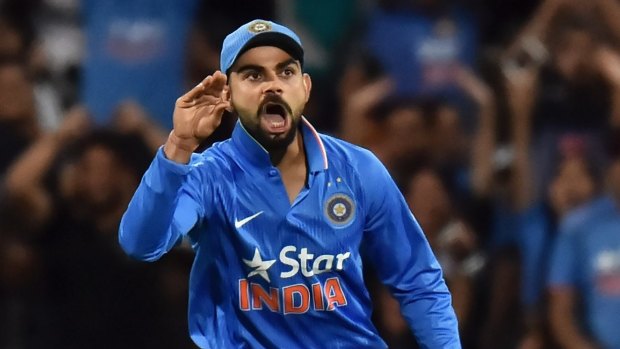 Stop talking ... Virat Kohli of India reacts after taking a catch to dismiss Steven Smith, who was commentating as he played.