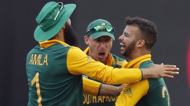 South Africa's JP Duminy celebrates with team mates Imran Tahir and Dale Steyne after he dismissed Sri Lanka's Tharindu Kaushal for a duck during their Cricket World Cup quarter-final match.