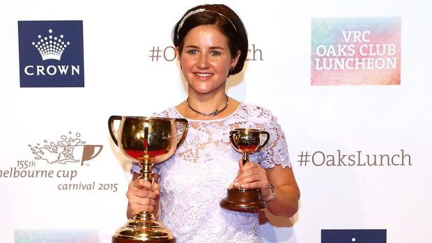 Michelle Payne shows off her Melbourne Cup trophies.