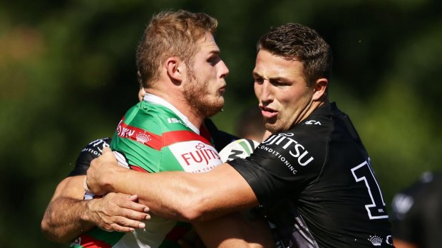 Brothers in arms: Tom Burgess (left), who is being shopped around by Souths, is tackled at training by brother Sam.