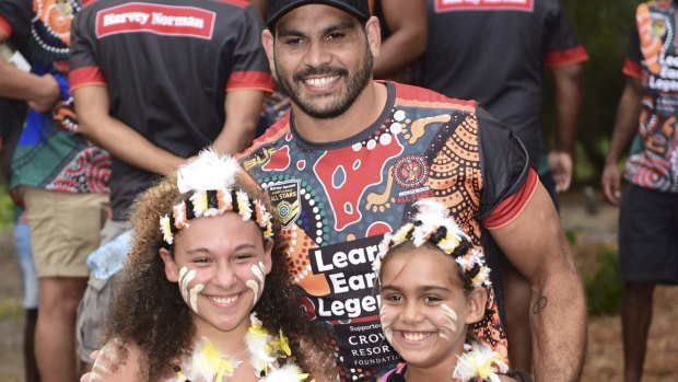 Greg Inglis poses with Stradbroke Island children at a pre-game camp for the Indigenous All Stars rugby league team.