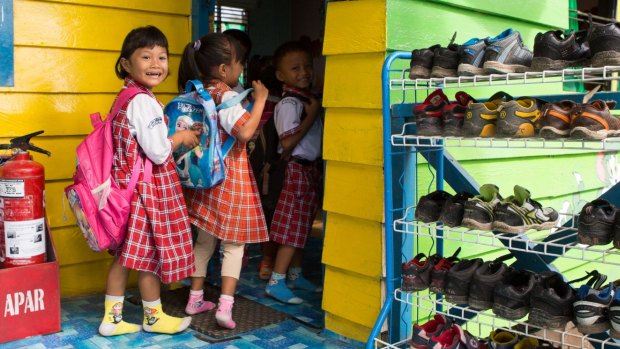 Children remove their shoes before they enter the classroom at Global Andalan school in Riau province. As part of the Fire-Free Villages program, APRIL is starting to reach out to school children. 