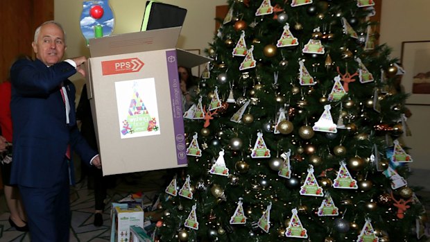 Malcolm Turnbull plays Santa's little helper in his office at Parliament House.