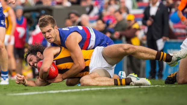 Bailey Dale tackles Matt Spangher during the VFL match between Footscray Bulldogs and Box Hill Hawks on Saturday.