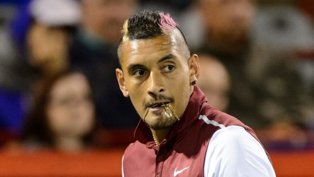 Nasty personal sledge ... Nick Kyrgios bites onto his chain during his match against Stan Wawrinka in Montreal.