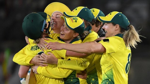Australia celebrate their win over England in the first Women's Ashes T20 match at North Sydney Oval.