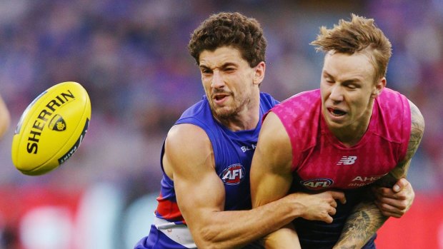 Out of Harmes way: Tom Liberatore tackles Melbourne's rising star James Harmes.