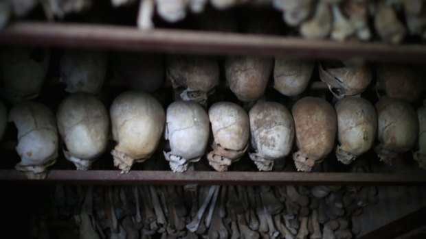 In 2014, metal racks hold the bones of thousands of genocide victims inside one of the crypts at the Nyamata Catholic Church memorial.