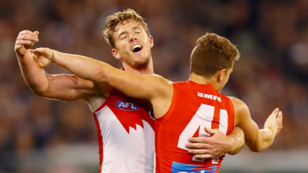 Thom Papley celebrates a goal with team mate Luke Parker .