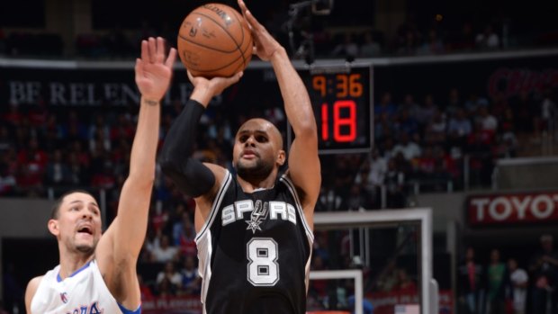 Patty Mills shoots past Austin Rivers of the Los Angeles Clippers.