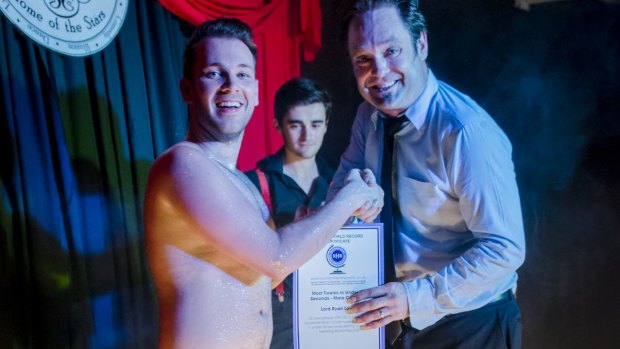 Boylesque performer "Lord" Ryan Lovat receives his certificate after setting a new world speed twerking record.