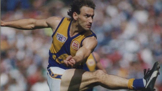 Peter Matera kicks the ball in the 1992 Grand Final, the first to be won by a non-Victorian team. Matera was awarded the Norm Smith Medal. 