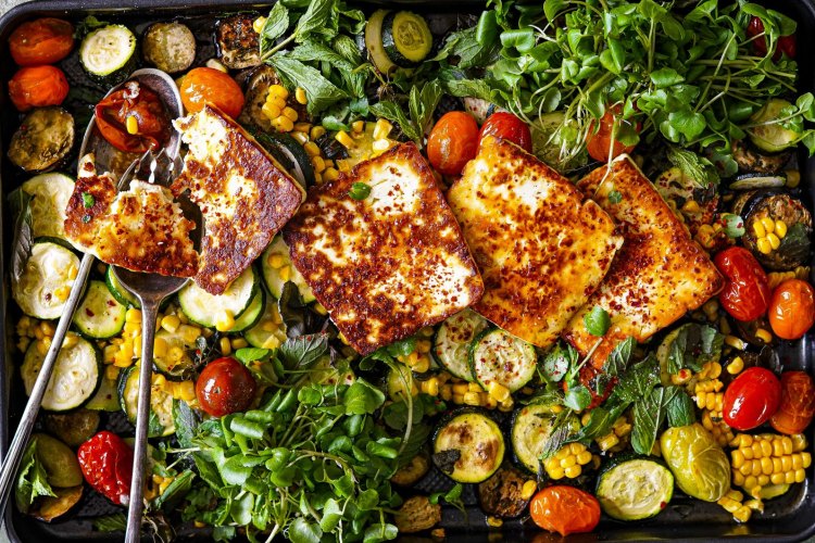 Summer veg and halloumi one-tray wonder. KatrinaÃÂ Meynink's summer traybake recipes for Good Food February 2022. One-tray wonders. Please credit KatrinaÃÂ Meynink. Good Food use only.