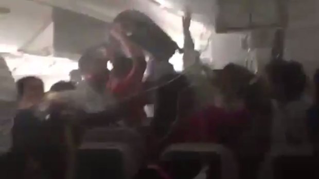 Images posted on social media in 2016 showed passengers scrambling to get their luggage from overhead compartments while their plane was on fire after landing in Dubai.