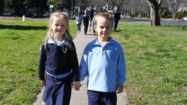 Tabitha Bobbin, 5, of Ainslie and Luke Jakubowski, 5, of Ainslie join fellow students of Ainslie Primary School participate in Winter Walk to School Week.