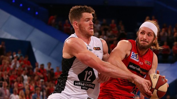 Collarbone injury: Melbourne's Lucas Walker guards Perth foward Jesse Wagstaff.