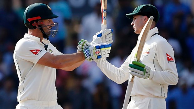 Rearguard action: Shaun Marsh celebrates his half-century with Peter Handscomb.