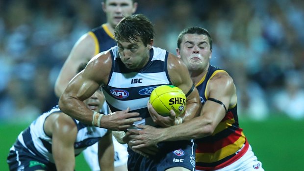 Corey Enright takes on Adelaide's Brad Crouch in 2014. He'll equal a Cats games record against the Crows in what's shaping as the match of the round. 