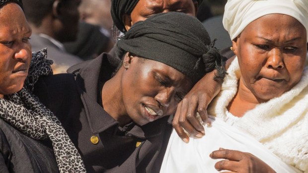 Akon Guode at her children's funeral.