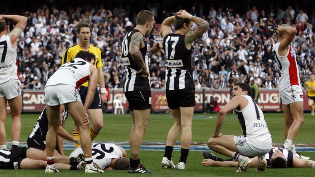 All tied up: Collingwood and St Kilda players react at the end of the tied 2010 AFL grand final.