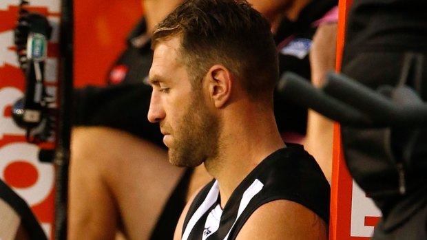 Hurt: Travis Cloke sits on the bench injured during the loss to Melbourne. P